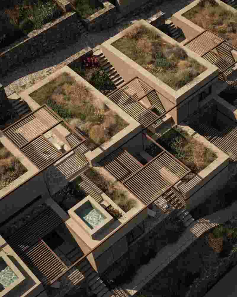 Planted rooftops enhancing thermal insulation and blending with the Limnos landscape.