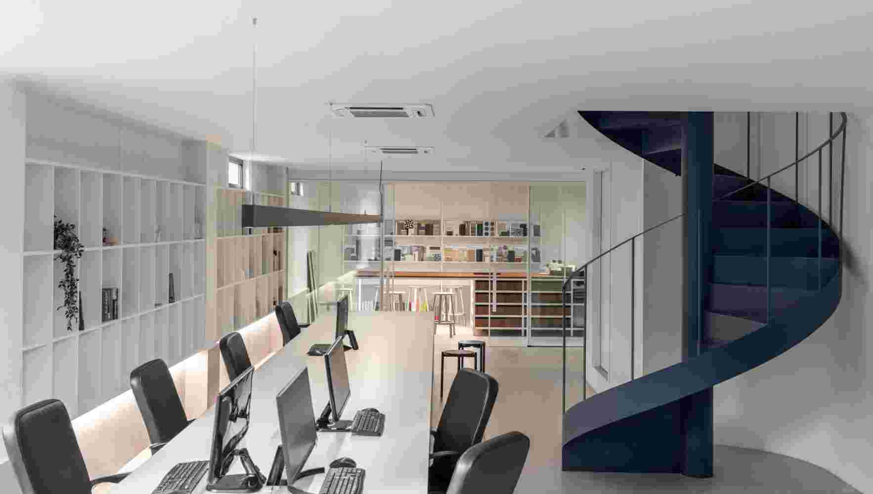 Open-plan office with functional desks.