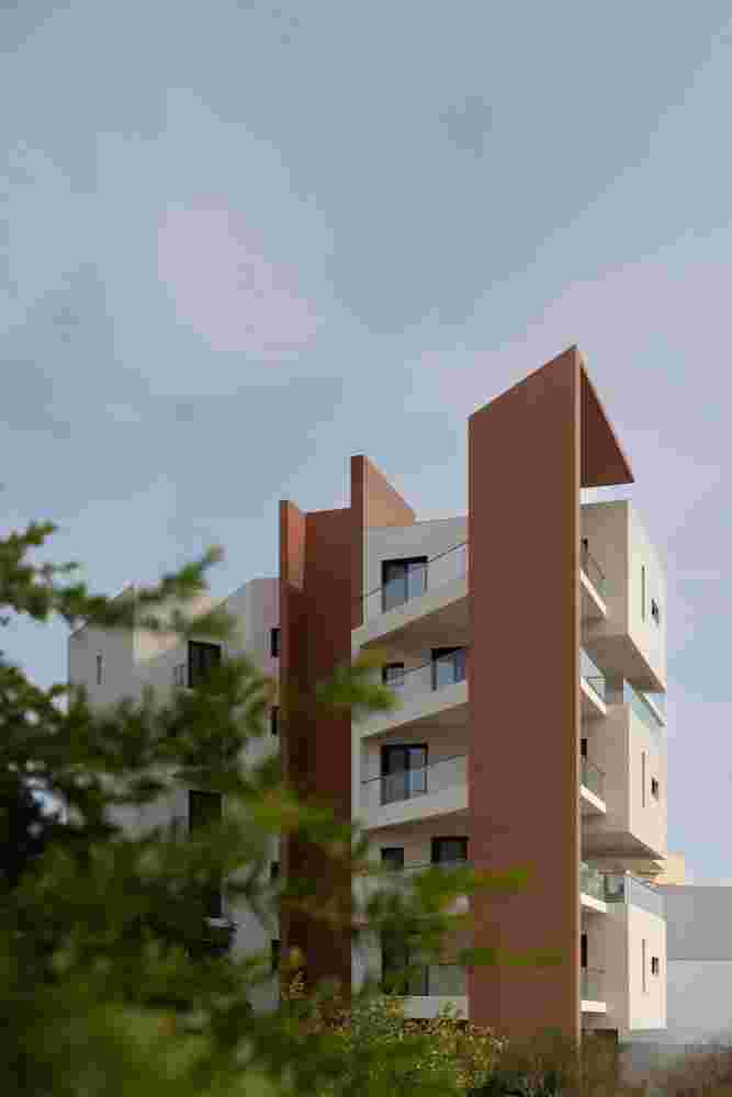 Contemporary apartment building in Spata Athens featuring cantilevered balconies and prismatic massing
