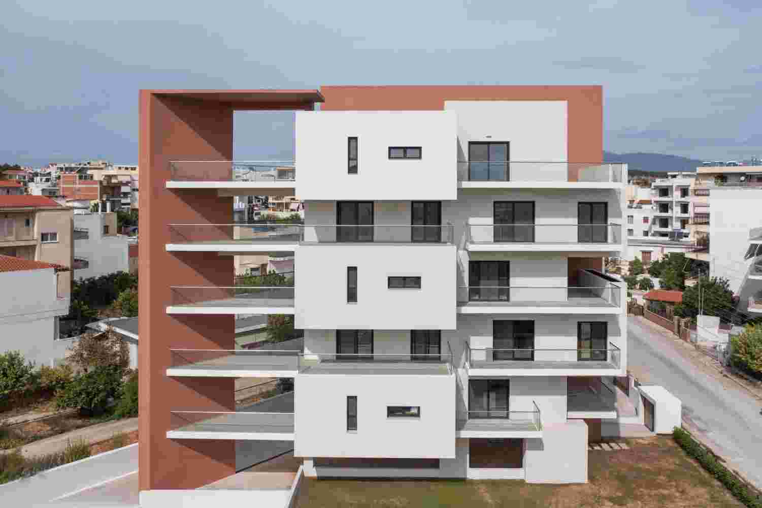 Prismatic contemporary residential building in Spata Athens with fragmented prismatic volumes and layered balconies