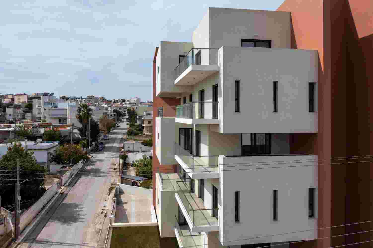 Corner view of Prismatic contemporary housing building in Spata Greece within urban neighborhood