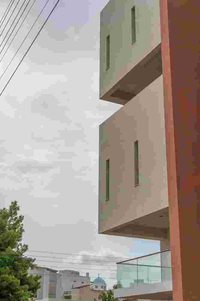 Contemporary multi-storey housing project Prismatic in Spata with sculptural massing strategy